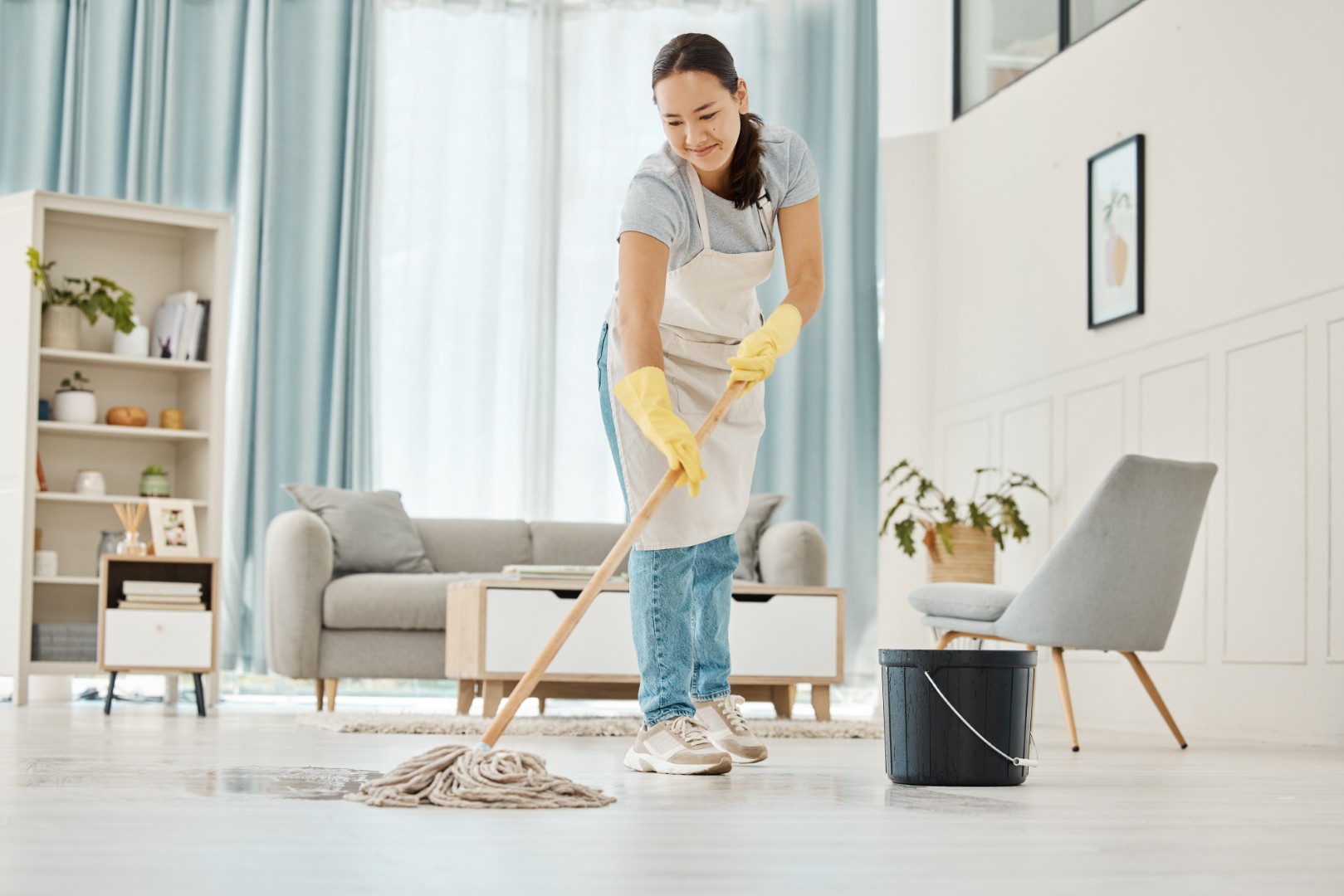 woman-mops-floor-in-bright-airy-living-room-2026-01-09-11-04-36-utc (Large)